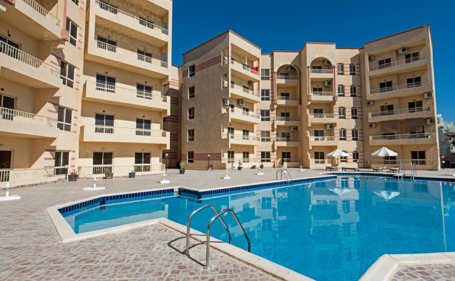 Large swimming pool with at a luxury tropical apartment resort complex